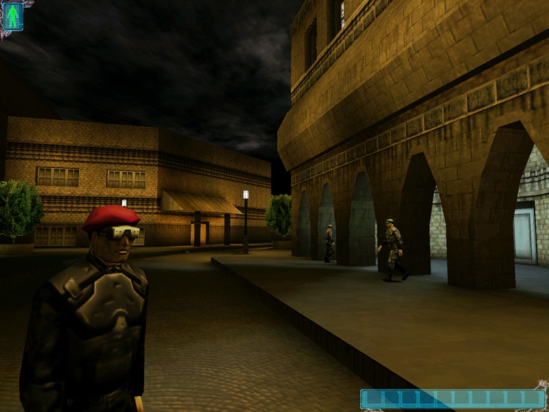 Paris, an MJ12 trooper with red beret and goggles walks by while similarly dressed UNATCO do in the background. This area is to the right of the previous image and can be seen out of Everett's windows.