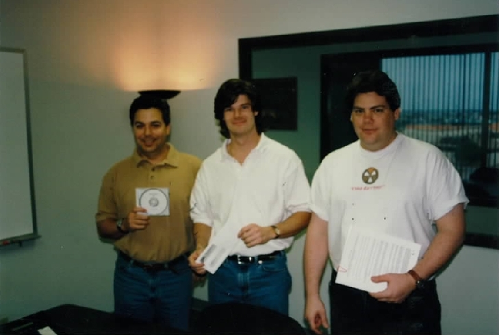 L-R: Scott Miller, Todd Hollenshead, & George Broussard. Scott is holding the source code, Todd is holding the "fat check", and George has the contract. L-R: Scott Miller, Todd Hollenshead, & George Broussard. Scott is holding the source code, Todd is holding the "fat check", and George has the contract.